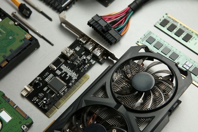 Photo of Graphics card and other computer hardware on gray textured background, above view