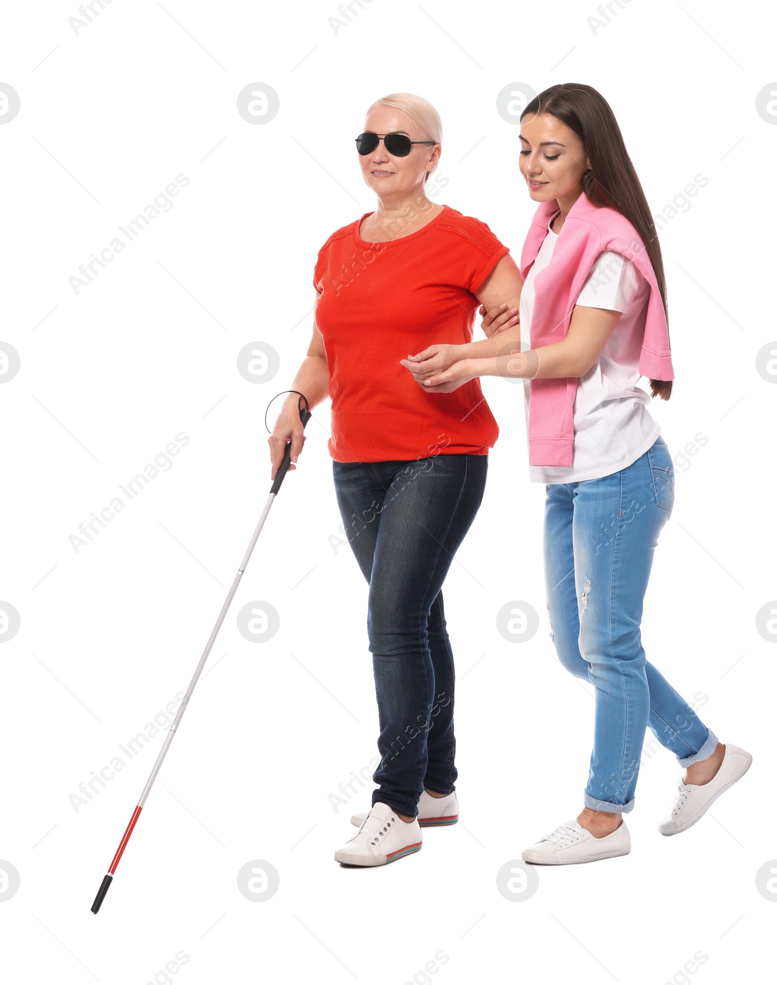 Photo of Young woman helping blind person with long cane on white background