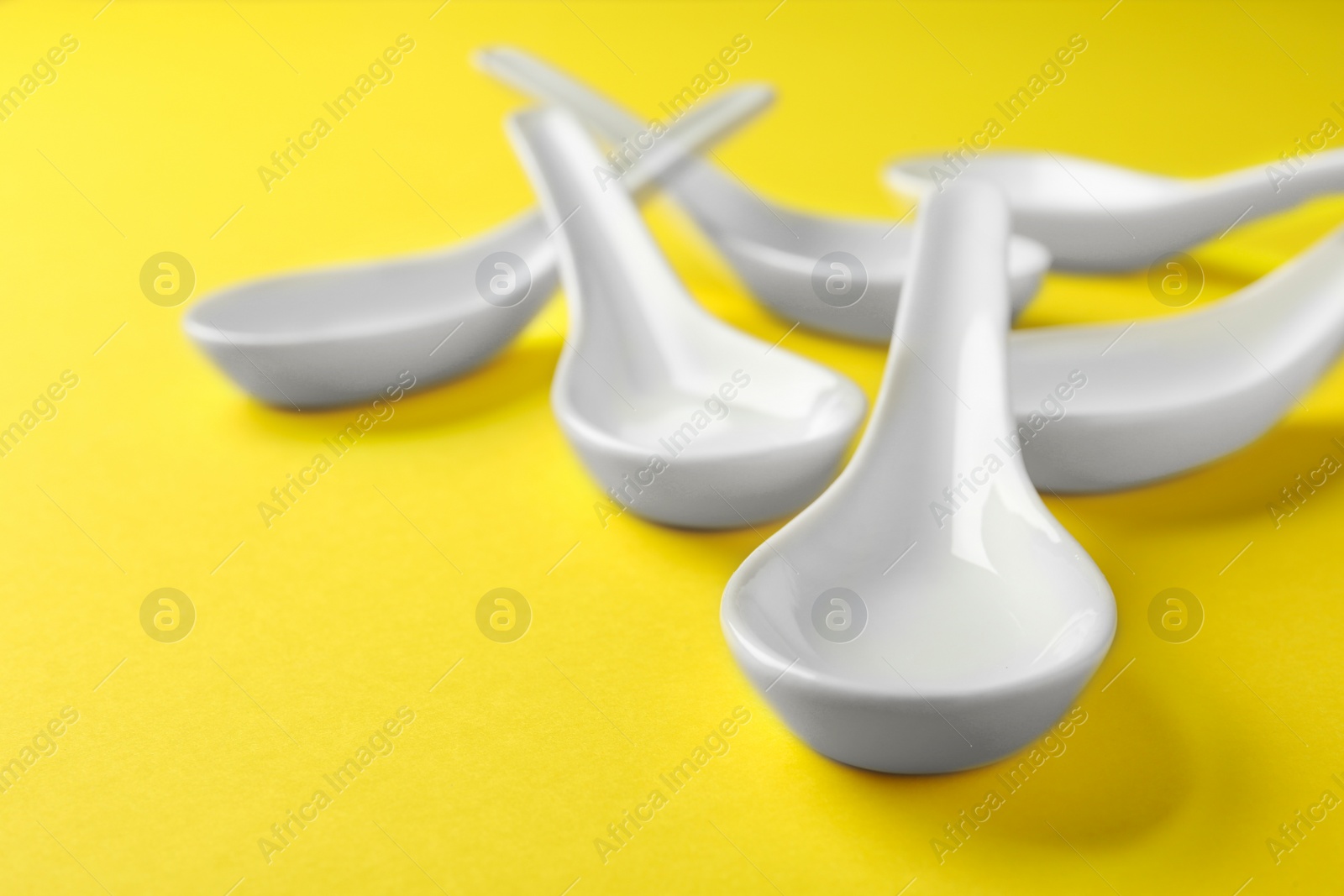 Photo of Clean Miso soup spoons on yellow background