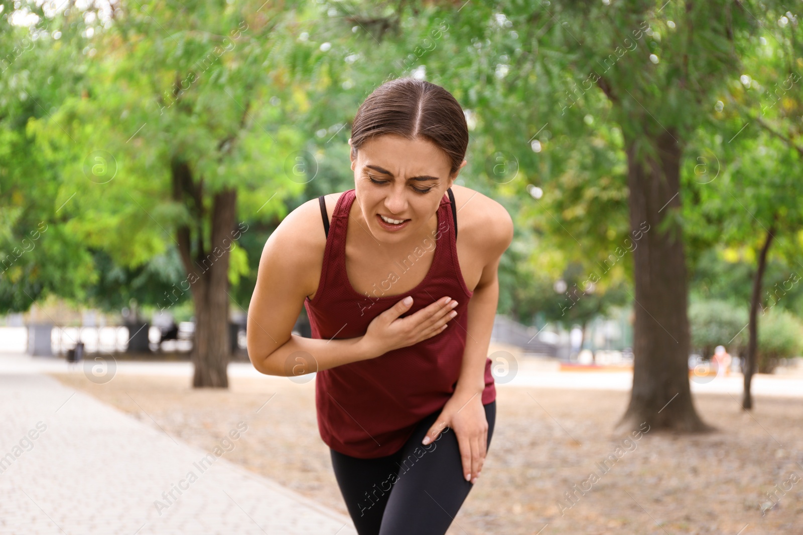 Photo of Young woman having heart attack while running in park