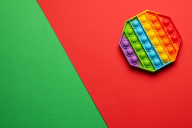 Rainbow pop it fidget toy on color background, top view. Space for text