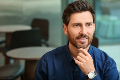 Photo of Portrait of handsome stylish man in cafe