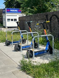 Photo of Warsaw, Poland - July 18, 2022: Row of modern electric scooters parked outdoors. Rental service