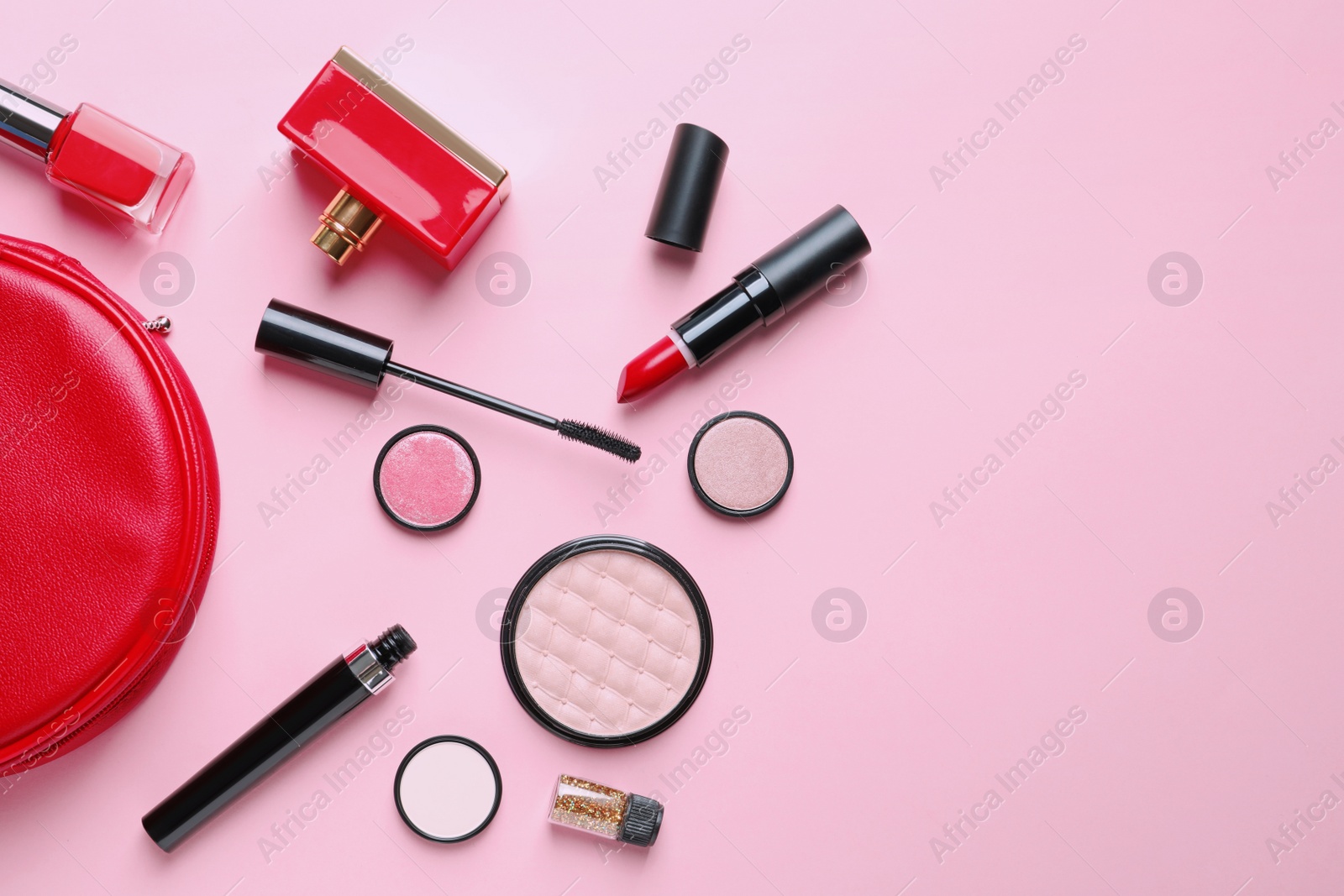 Photo of Makeup products with cosmetic bag on color background