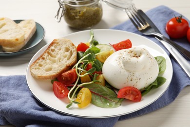 Photo of Delicious burrata salad served on white wooden table