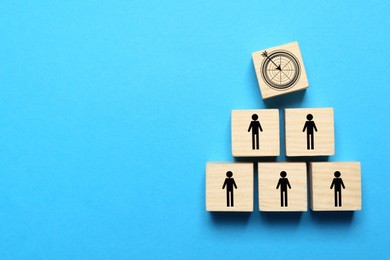 Image of Cubes with icons on light blue background, top view. Target and human illustrations