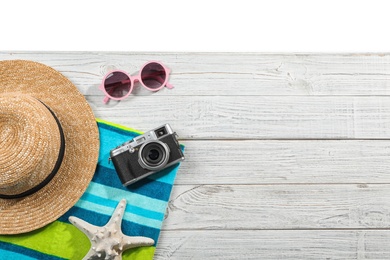 Photo of Flat lay composition with beach accessories on wooden background. Space for text