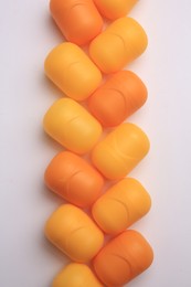 Photo of Sveti Vlas, Bulgaria - June 30, , 2023: Orange plastic capsules from Kinder Surprise Eggs on white background, flat lay