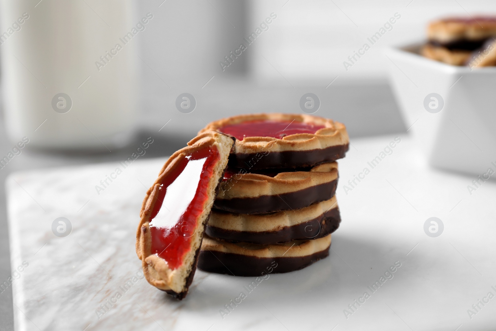 Photo of Delicious cookies with chocolate and jam on light table, closeup