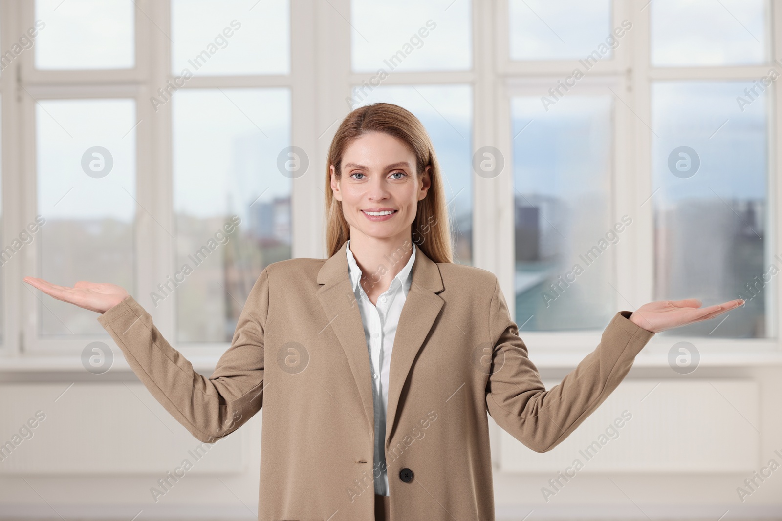 Photo of Happy real estate agent showing new apartment