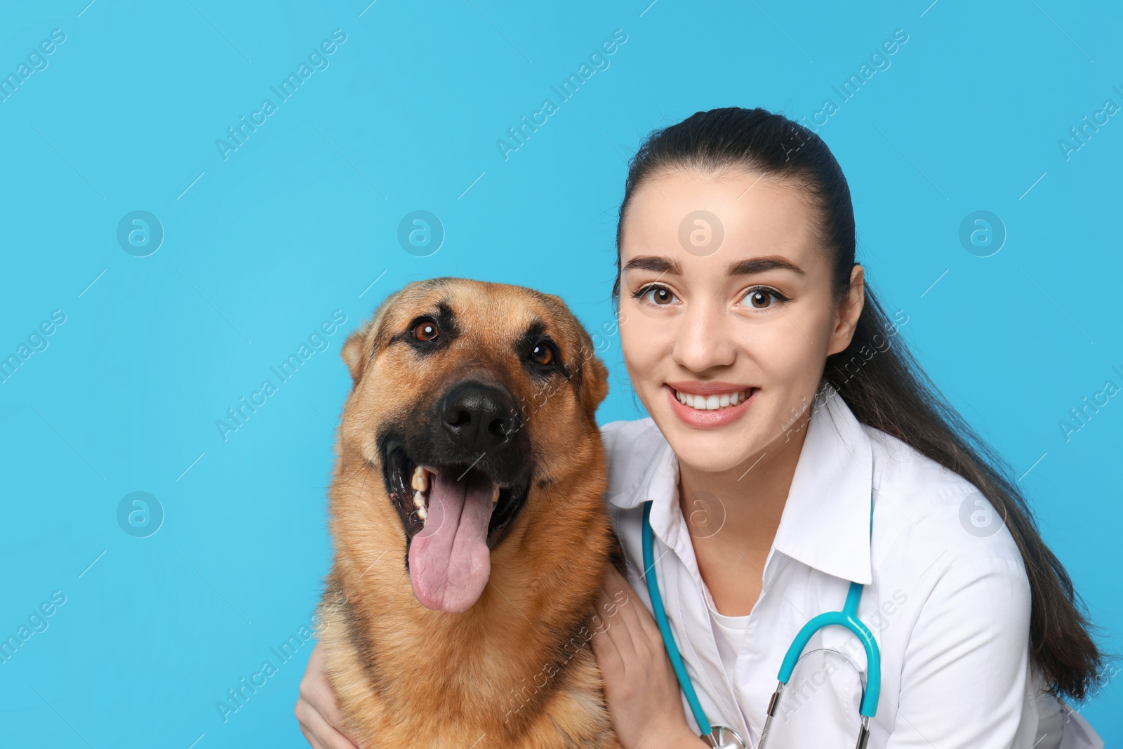 Photo of Veterinarian doc with dog on color background