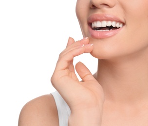 Photo of Young woman with beautiful smile on white background, closeup. Teeth whitening