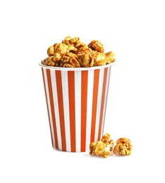 Photo of Delicious popcorn with caramel in paper bucket on white background