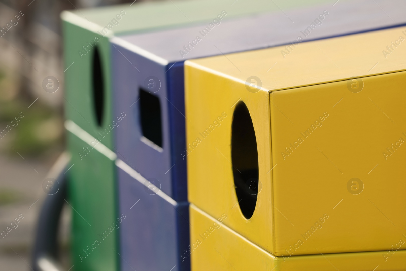 Photo of Garbage containers for waste sorting outdoors, closeup