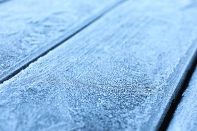 Beautiful hoarfrost on wooden surface, closeup view