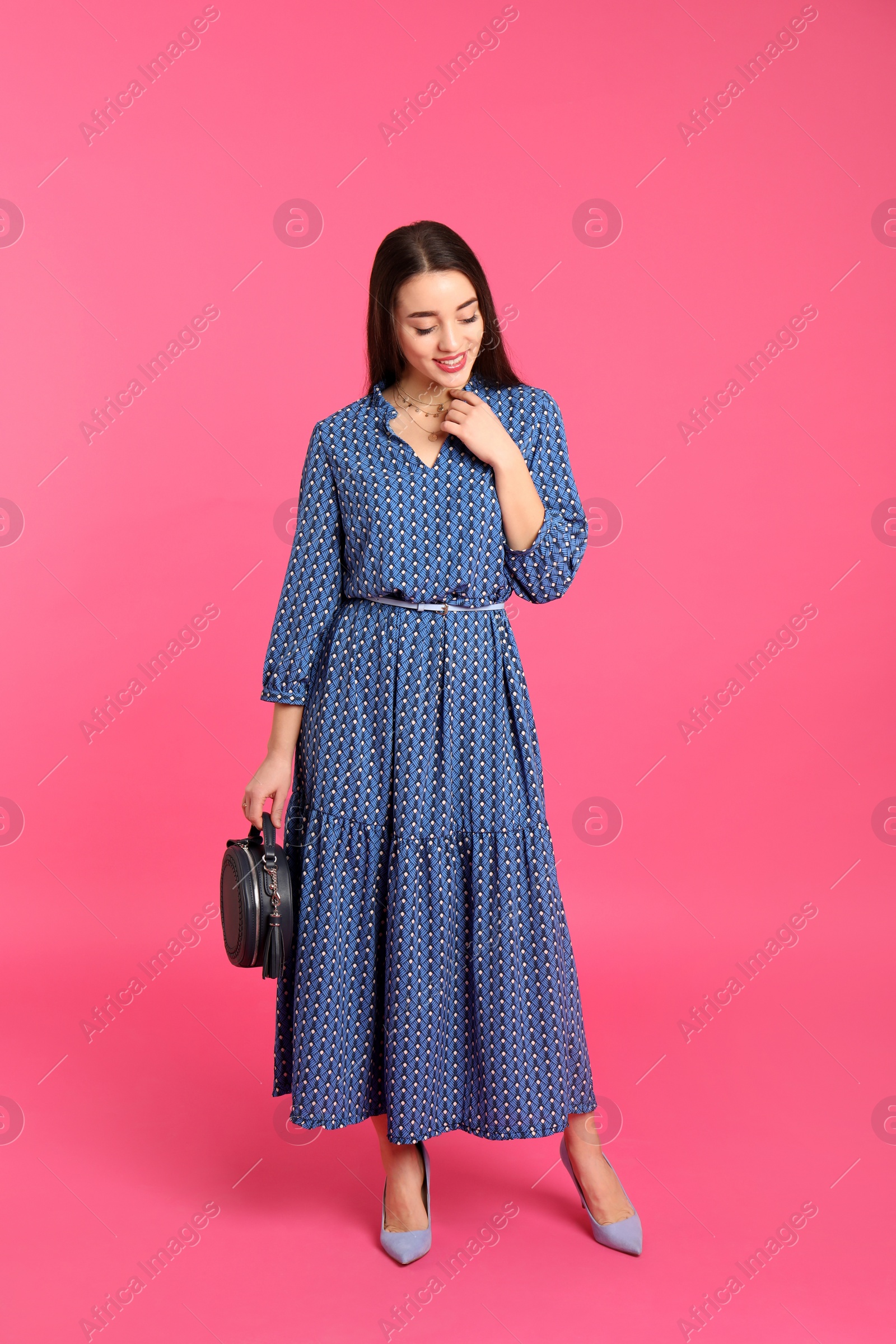 Photo of Portrait of beautiful young woman in stylish dress on color background