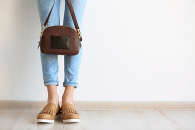 Photo of Young woman wearing elegant shoes indoors, closeup