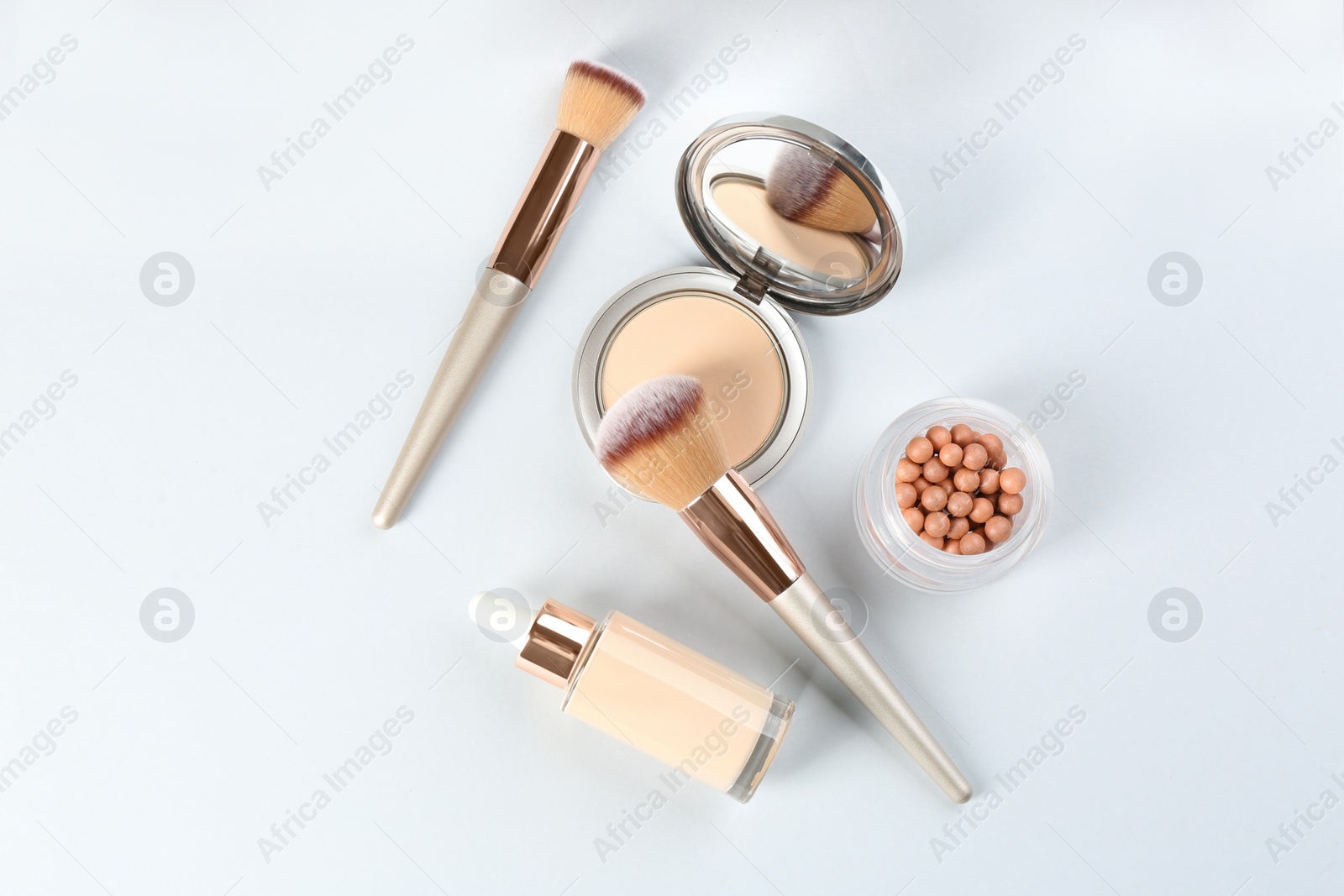 Photo of Flat lay composition with makeup brushes on light background