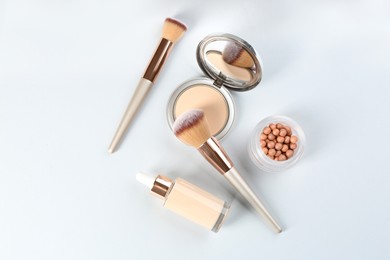 Photo of Flat lay composition with makeup brushes on light background