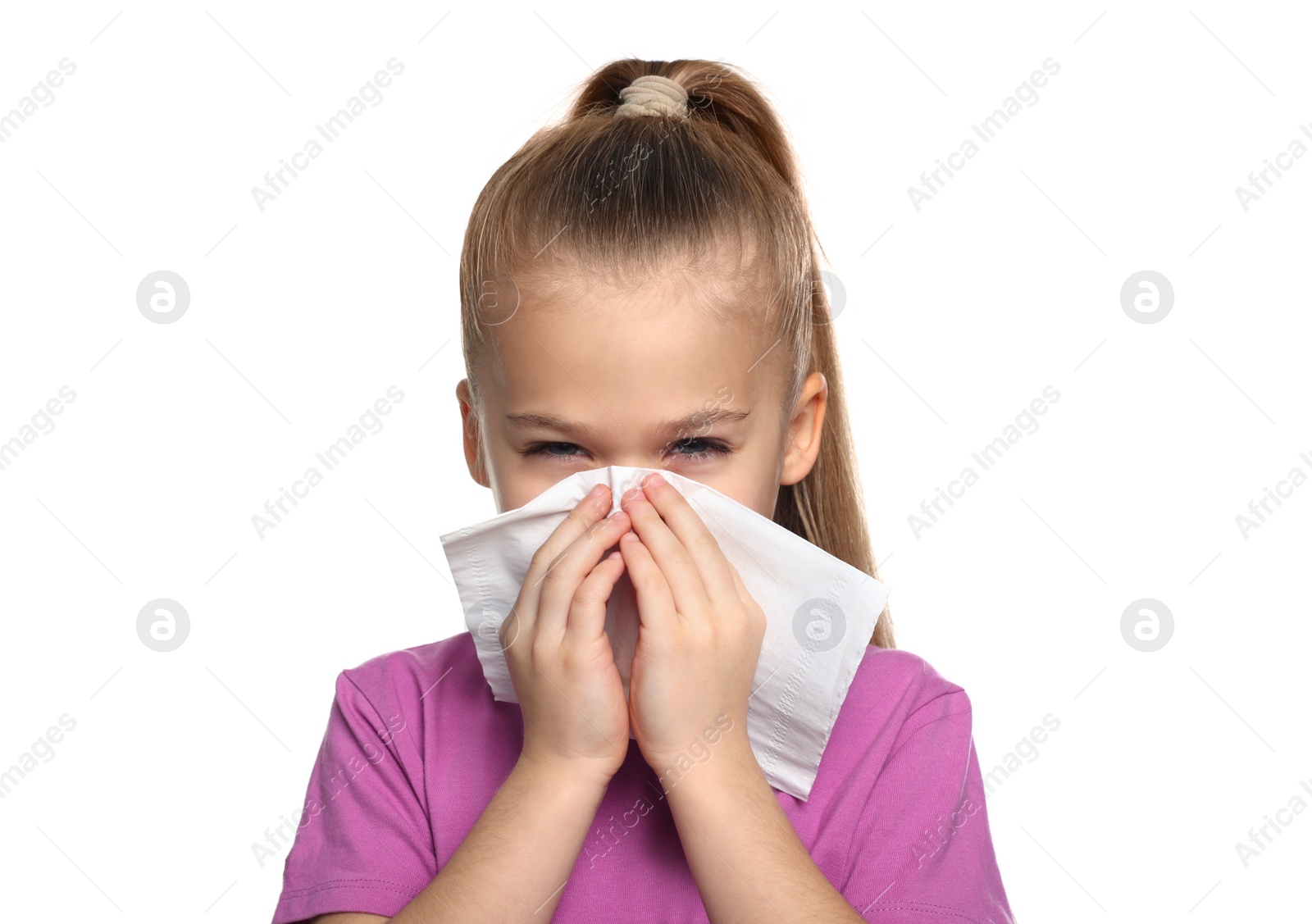 Photo of Sick girl blowing nose in tissue on white background. Cold symptoms