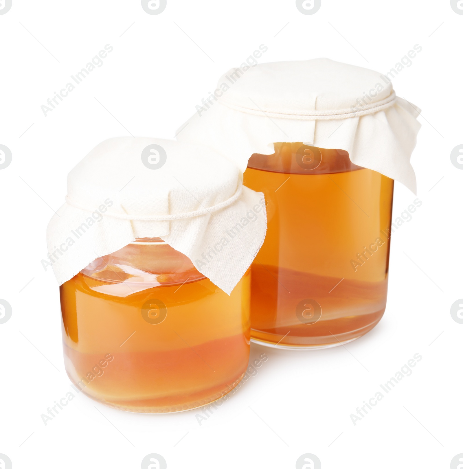 Photo of Tasty kombucha in glass jars isolated on white