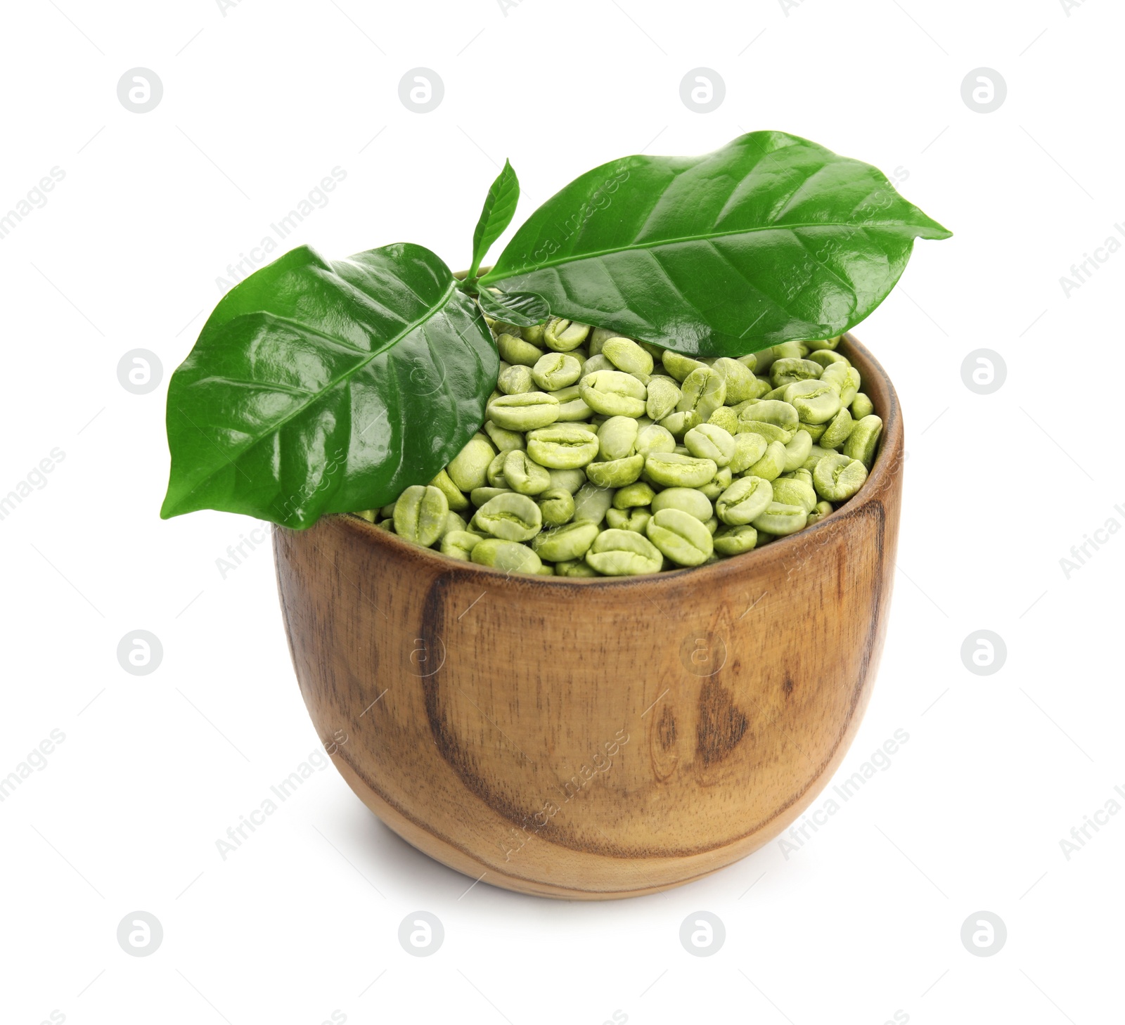 Photo of Wooden bowl with green coffee beans and fresh leaves on white background