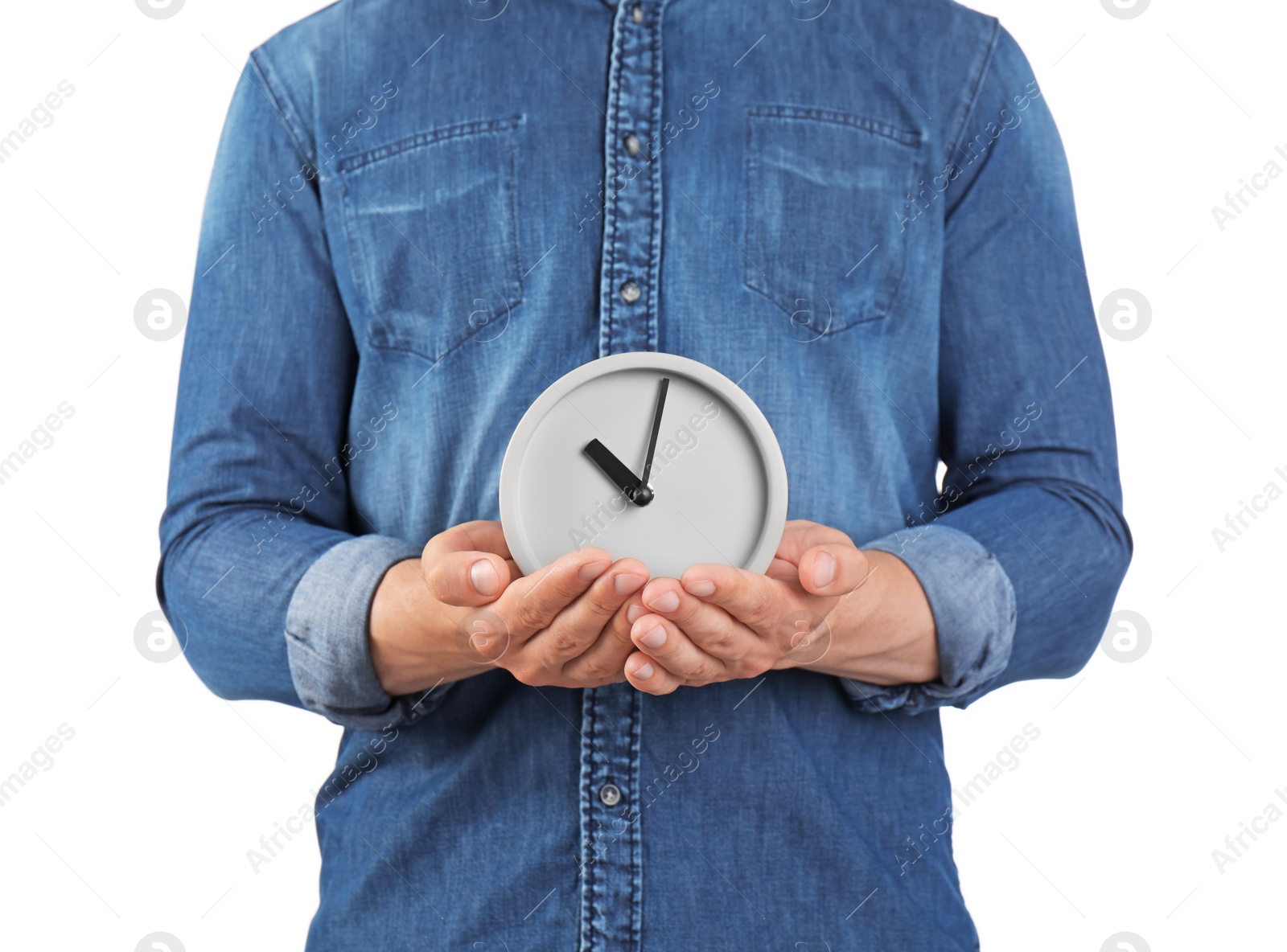 Photo of Young man holding clock on white background. Time management