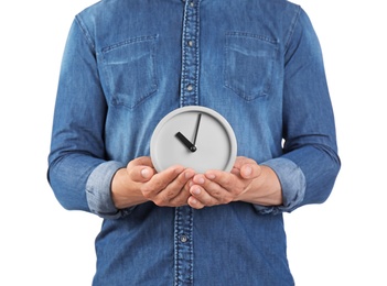 Young man holding clock on white background. Time management