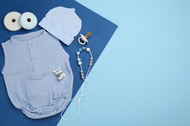 Flat lay composition with baby clothes and accessories on color background. Space for text