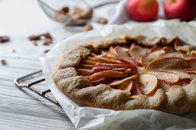 Photo of Delicious apple galette on white wooden table, closeup