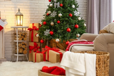 Stylish interior with beautiful Christmas tree and gift boxes