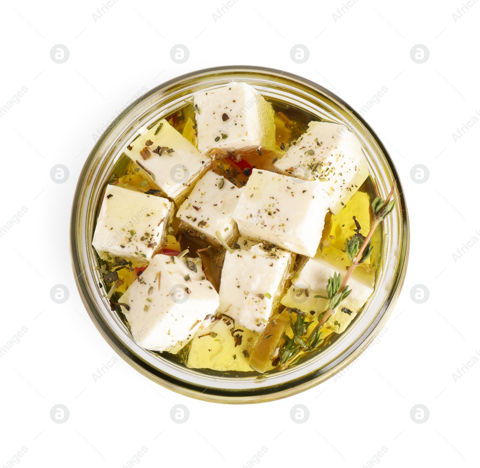 Photo of Open jar with feta cheese marinated in oil on white background, top view. Pickled food