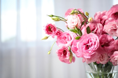 Photo of Beautiful pink Eustoma flowers on light background, closeup. Space for text