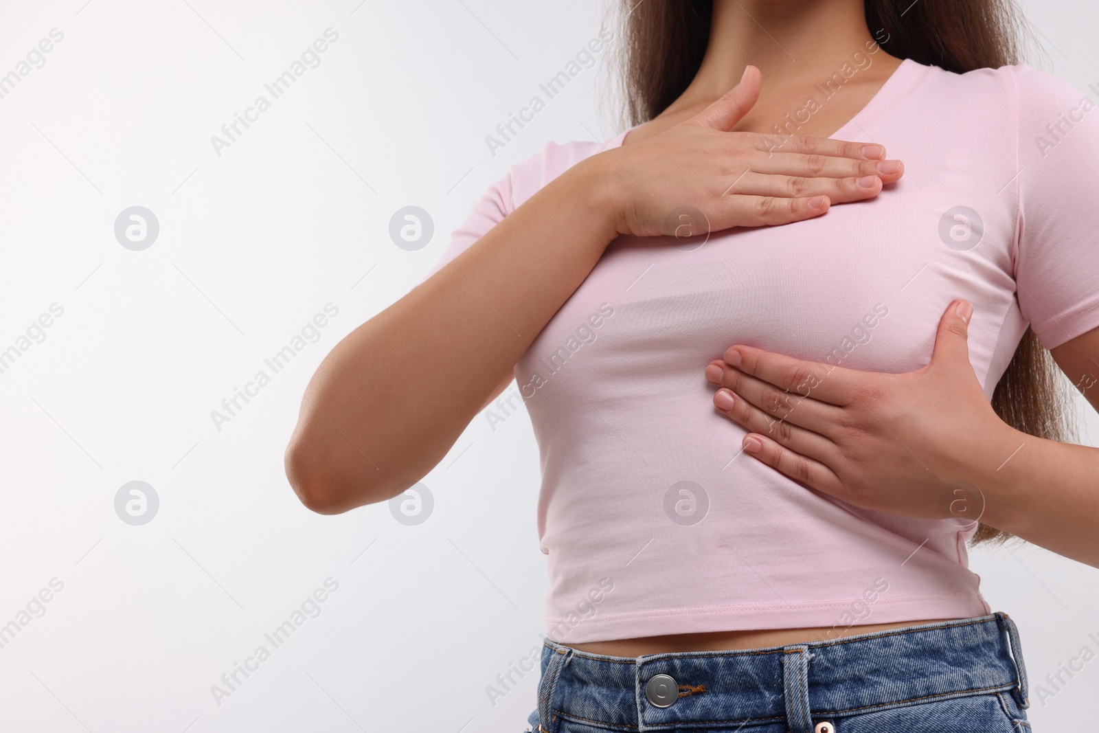 Photo of Woman doing breast self-examination on white background, closeup. Space for text