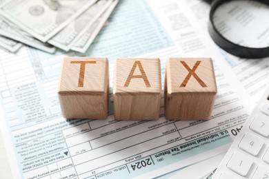 Wooden cubes with word Tax on documents, closeup