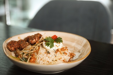 Photo of Plate with rice and meat balls served on table