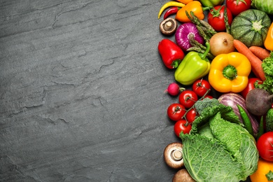 Photo of Flat lay composition with fresh vegetables on black table. Space for text