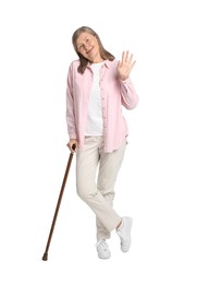 Photo of Senior woman with walking cane waving on white background