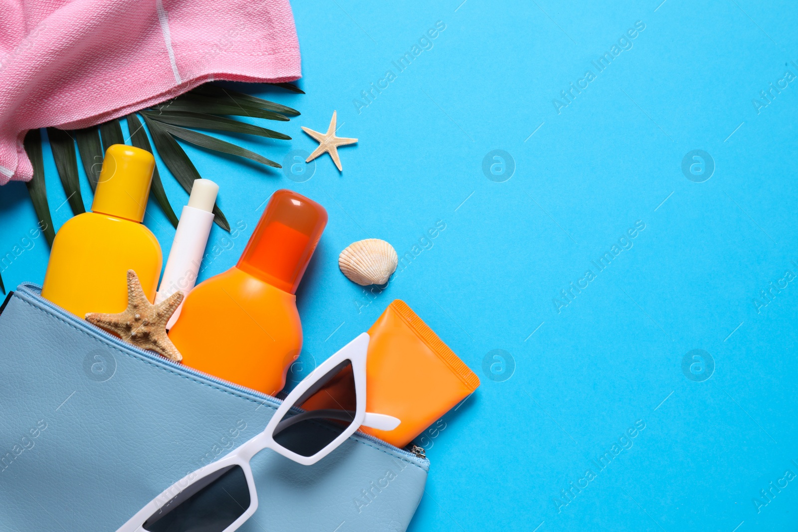 Photo of Flat lay composition with sun protection products on blue background. Space for text