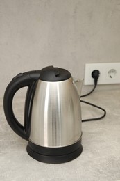 Photo of Modern electric kettle on counter in kitchen