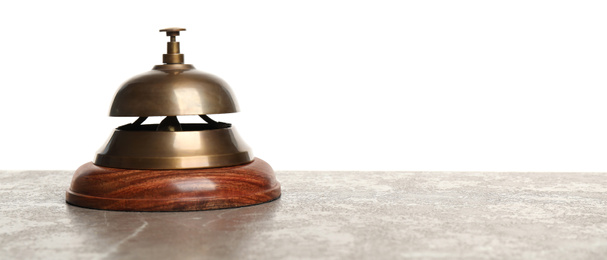 Hotel service bell on grey stone table against white background