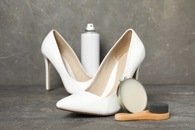 Photo of Composition with stylish footwear and shoe care accessories on grey background
