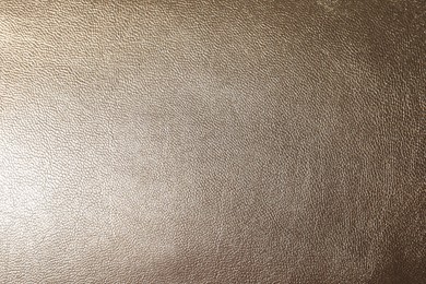 Photo of Texture of light brown leather as background, closeup