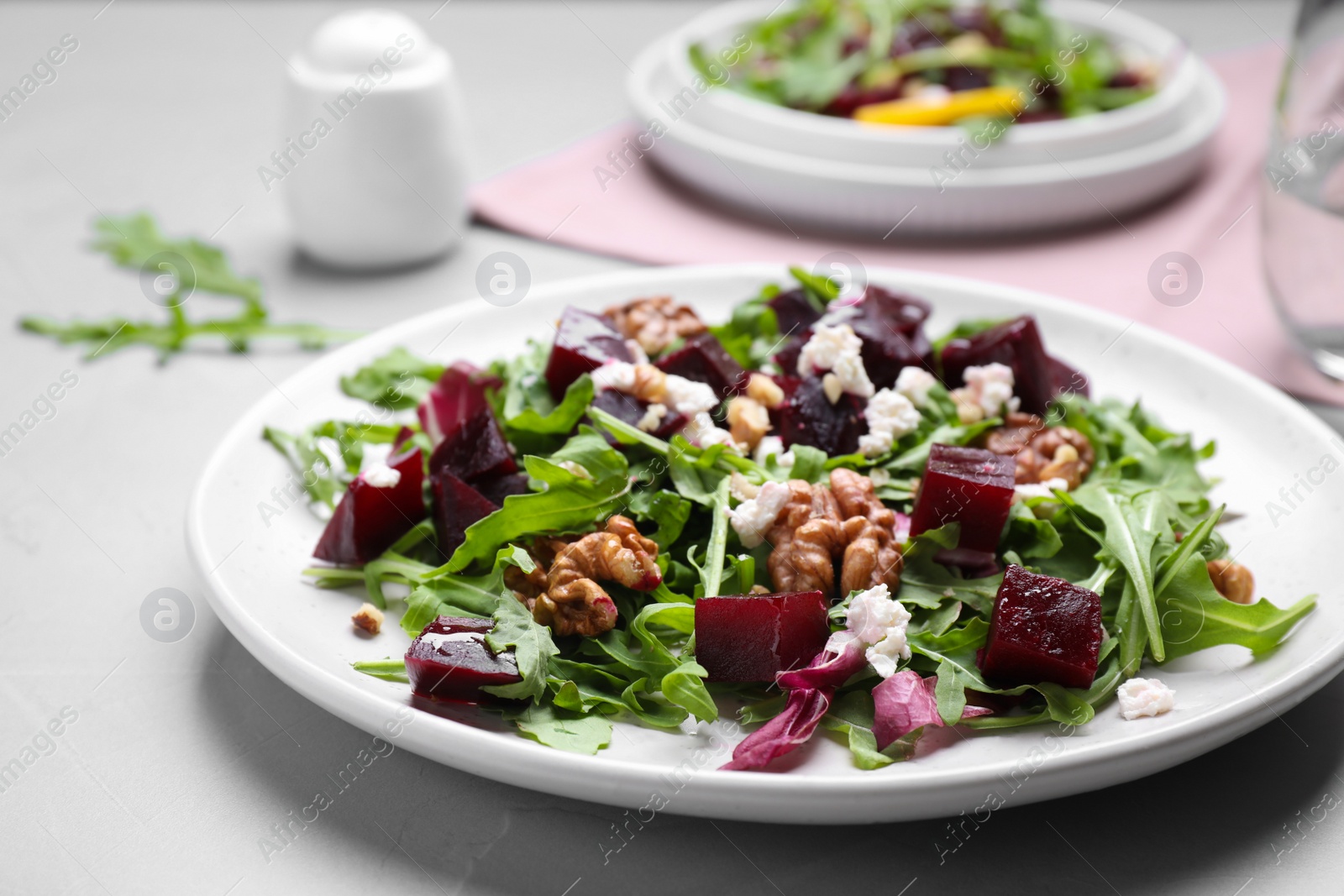 Photo of Delicious beet salad served on grey table, closeup