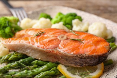 Photo of Healthy meal. Tasty grilled salmon with vegetables on plate, closeup