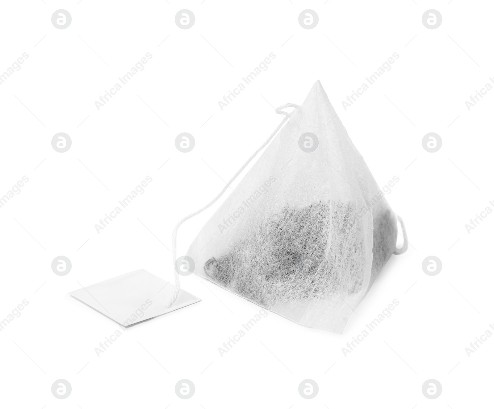 Photo of One new tea bag with label on white background