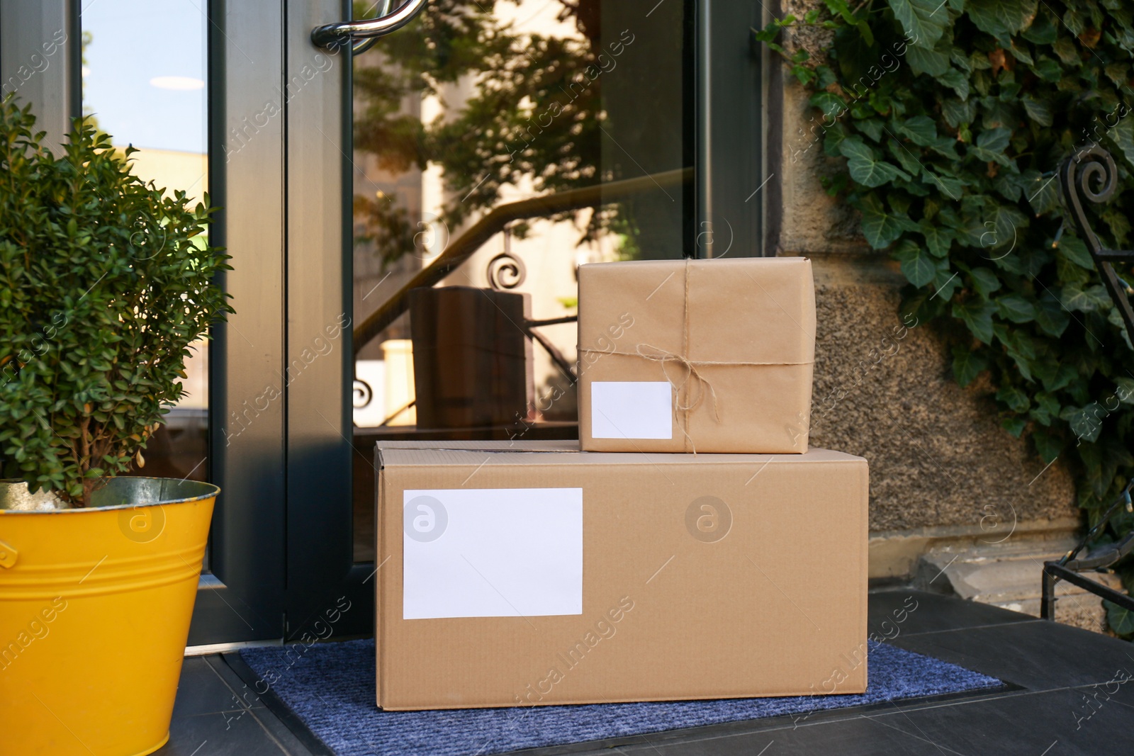 Photo of Delivered parcels on door mat near entrance