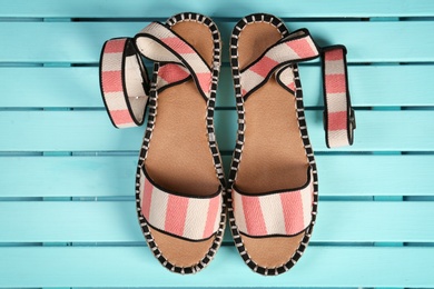 Photo of Pair of female shoes on wooden background, top view