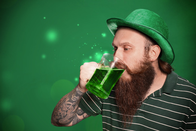 Image of Man drinking beer on green background. St. Patrick's Day celebration