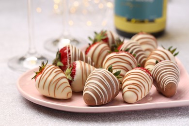 Delicious chocolate covered strawberries on light table, closeup